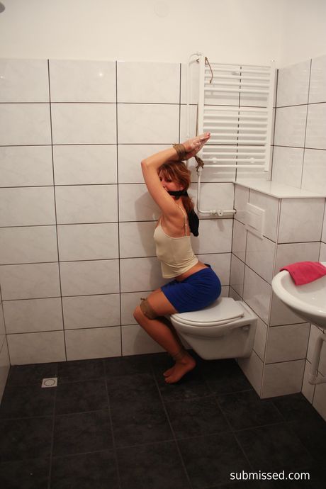 Brown-haired babe Eve is tied up and teased with a glass dildo