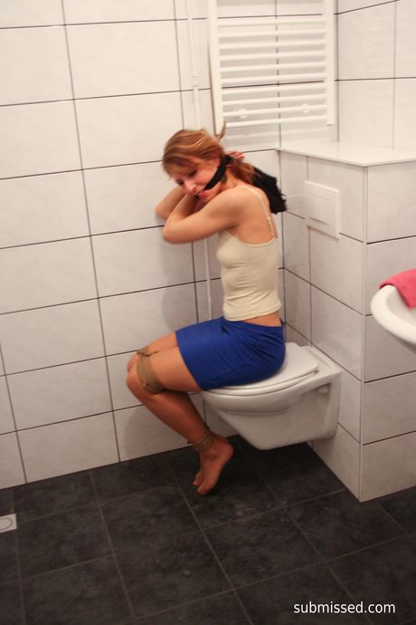 Brown-haired babe Eve is tied up and teased with a glass dildo