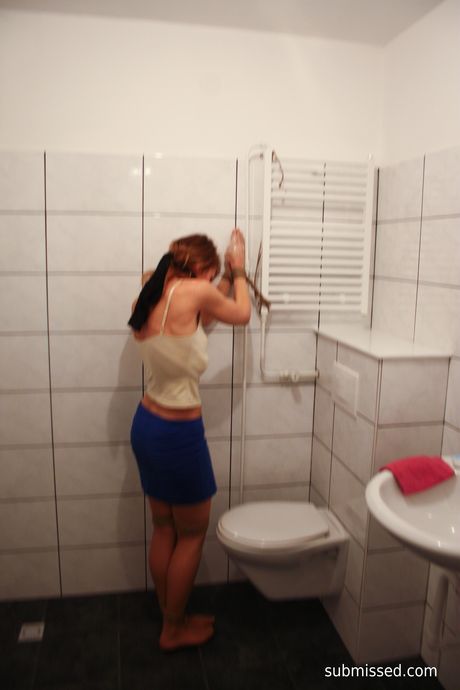 Brown-haired babe Eve is tied up and teased with a glass dildo