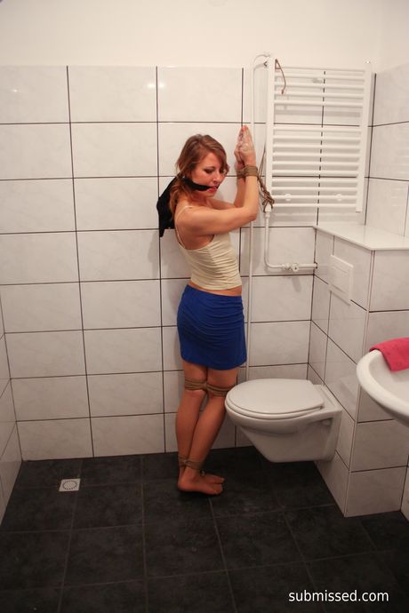 Brown-haired babe Eve is tied up and teased with a glass dildo