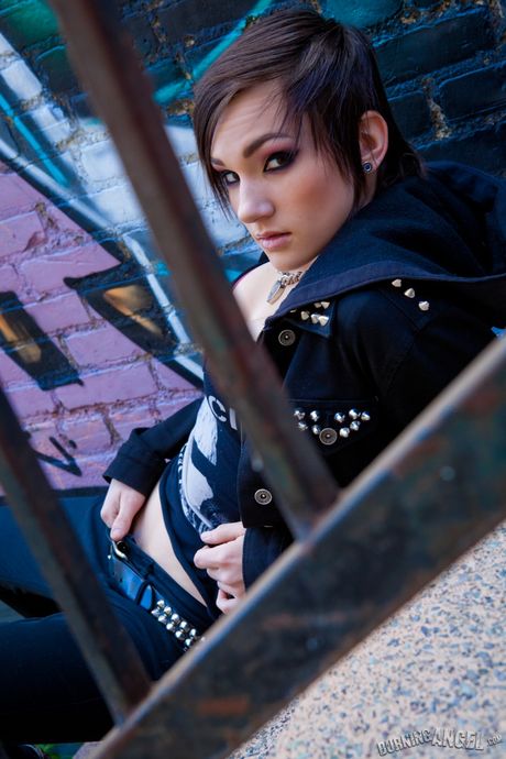 Inked brat Nikki Hearts presents her petite tits and fingers her pussy