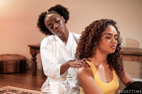 Lesbian lovers Ana Foxxx and Scarlit Scandal kiss and caress each other