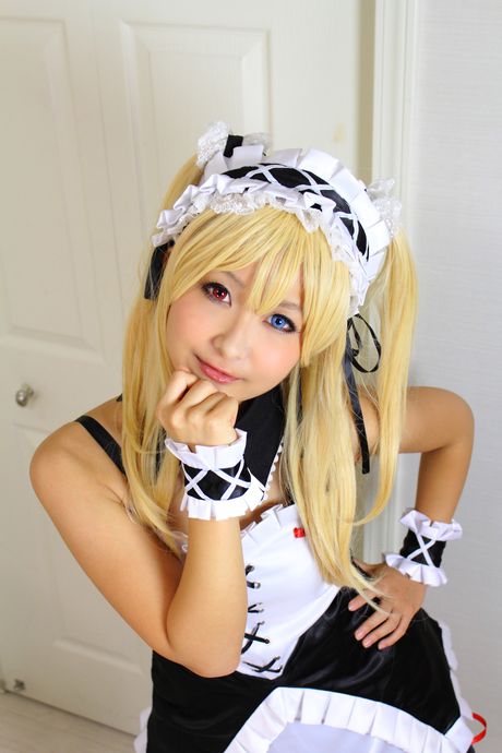 Blonde japanese babe Kyuru reveals her tiny boobs and poses in a maid outfit