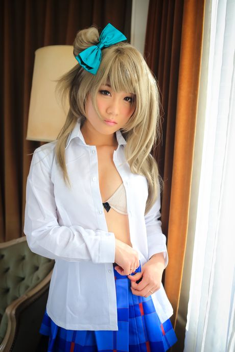 Blond japanese teen Eri Kitami exposes her natural small tits and poses in a solo