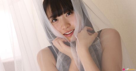 Asian covergirl Hijiri Sachi removes a black dress before a nude modelling gig