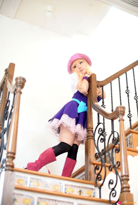 Blonde japanese girl Saku wears a hat and gloves while modelling in a garden