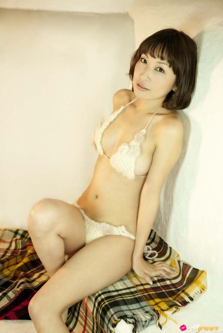 Den asiatiske model Mayumi Ono nøgner sig på en sexet måde i en seng