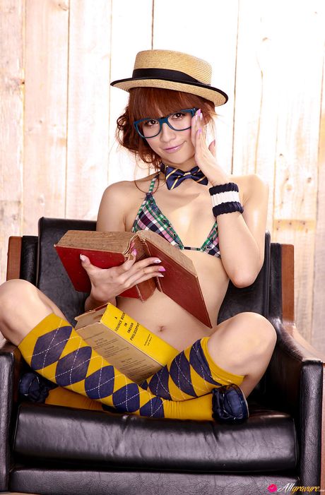 アジア美人の優木まおみがビキニ姿でモデルをしながら髪にリボンをつけている