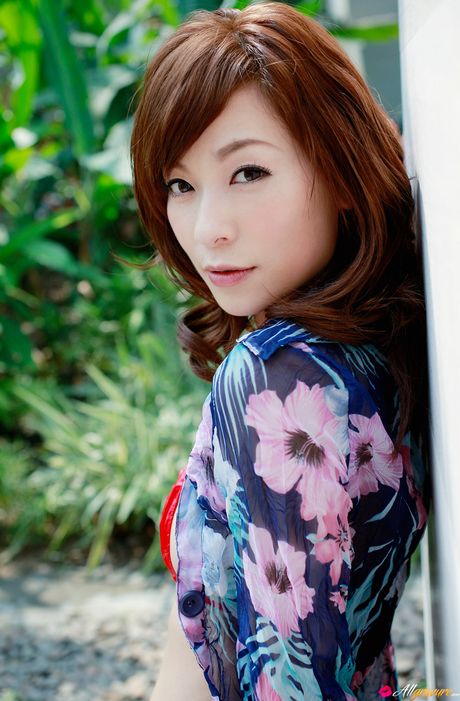 Bikini clad Asian MILF Kaho Kasumi posing on the patio