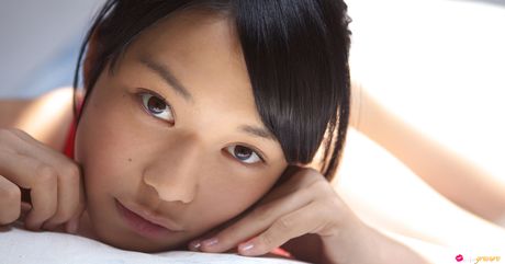 Asian cutie Tomoe Yamanaka removes her swimsuit and poses in white stockings