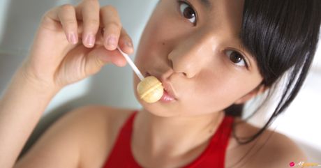 Asian cutie Tomoe Yamanaka removes her swimsuit and poses in white stockings