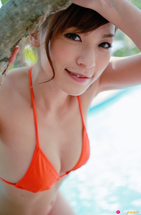 Asian babe Kaho Kasumi exhibits her amazing melons and poses in a red bikini