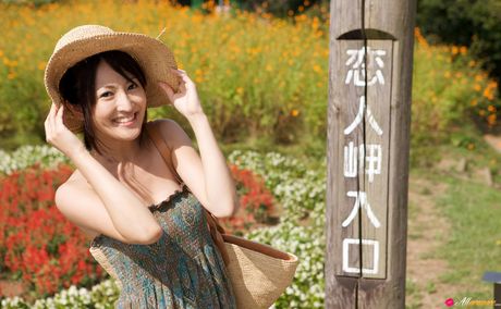 Asian girl Nao Utahara gets naked in a field of flowers