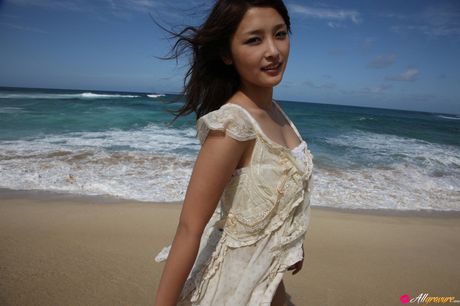 Asian babe Rika Ishikawa gets naked on a blanket on a blanket