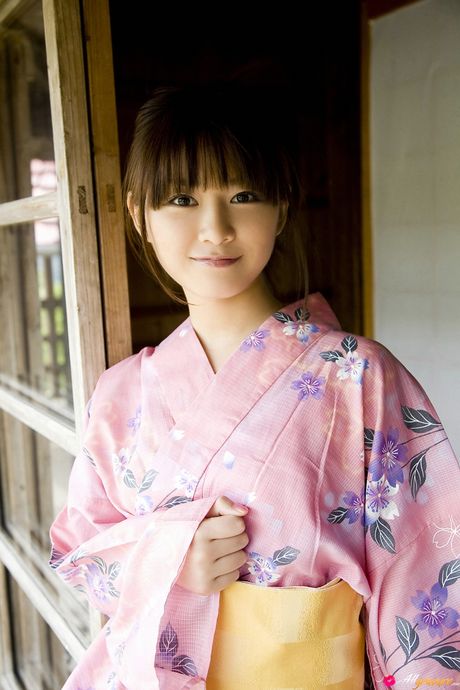 Asian girl Natsumi Kamata gets naked on a sofa in a Japanese kimono