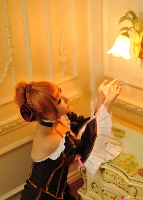 Striking japanese redhead Saku gets naked on a couch while wearing a pink bow