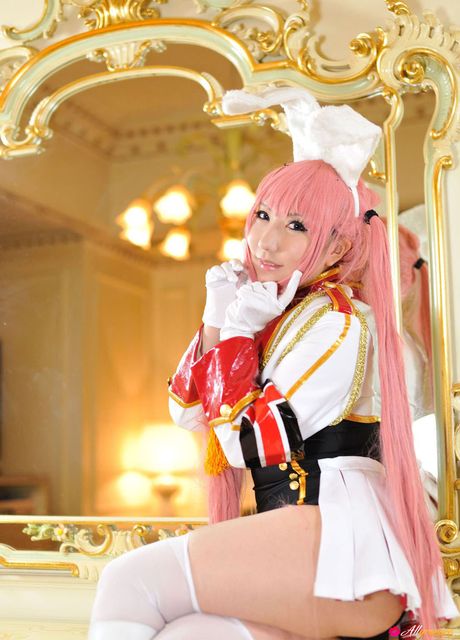 Asian doll Saku sports pink hair while modelling in white stockings