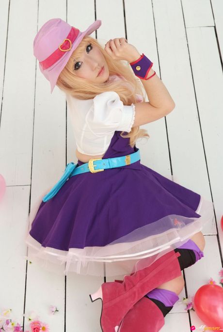 Asian doll Saku models a hat and boots in a field of sunflowers