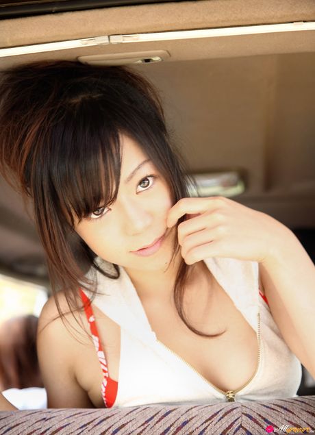 Devastating japanese teen Mana removes her bikini and highlights her large boobs on the beach