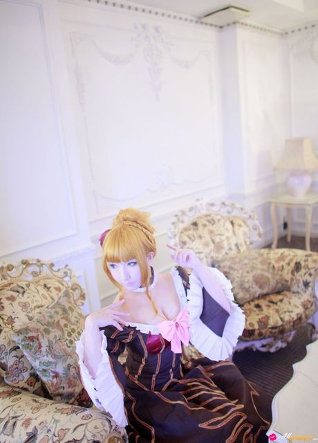 Asian stunner Saku wears a black dress before getting naked on a sofa