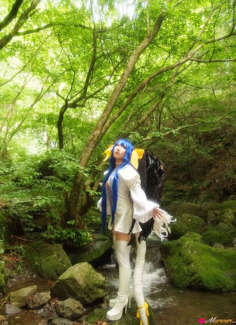 Asian teen Ayaka models a long dress in a forest with blue hair