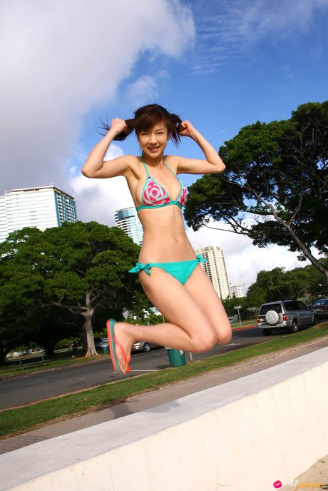 Asian stunner Aki Hoshino displays her large boobs and presents herself au naturel in the countryside