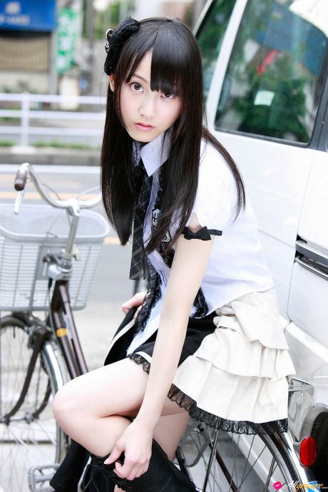 Dark haired teen Rena Matsui gets naked on a bicycle in a school uniform