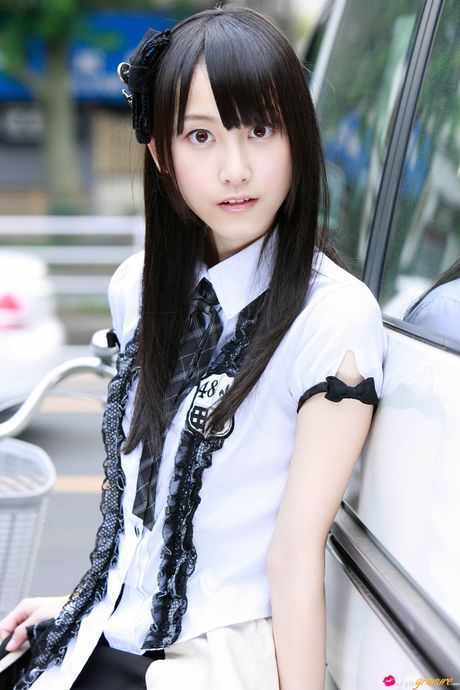 Dark haired teen Rena Matsui gets naked on a bicycle in a school uniform
