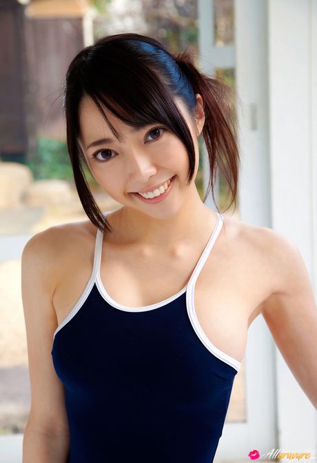 Asian covergirl Ai Nomura gets undressed on a bed in knee socks