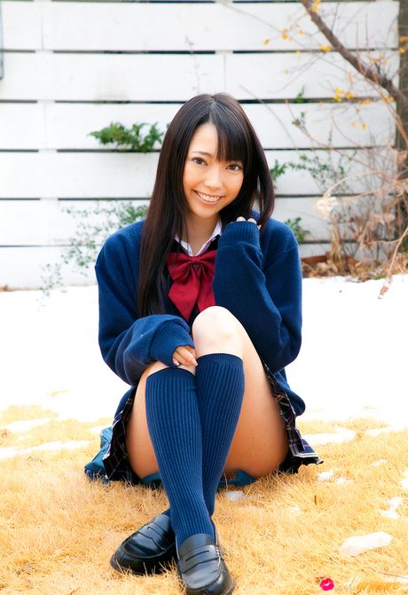 Asian covergirl Ai Nomura gets undressed on a bed in knee socks