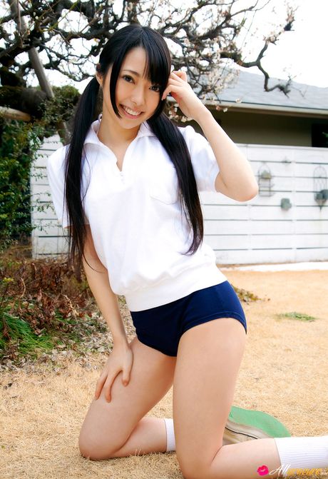 Asian covergirl Ai Nomura gets undressed on a bed in knee socks