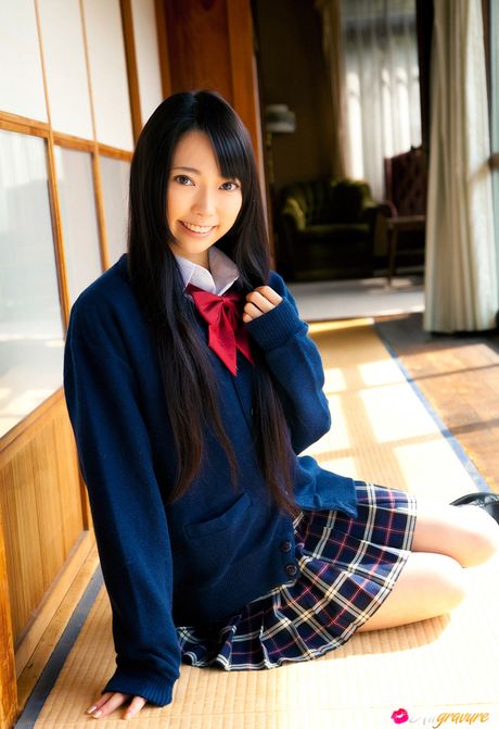 Asian covergirl Ai Nomura gets undressed on a bed in knee socks