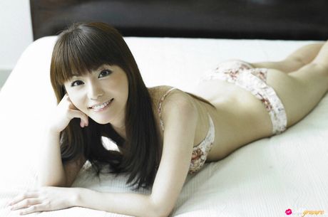 Asian teen Yuki Morisaki slips off her dress before getting naked in a bedroom