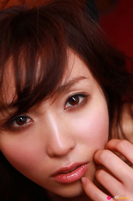 Asian beauty Risa Yoshiki presents her big racks and poses in fishnet stockings