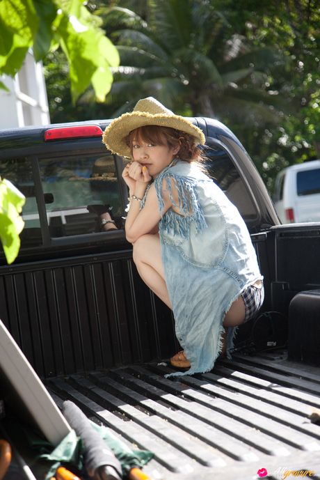 Asian beauty Ai Takahashi flaunts her natural small tits and poses in a hat outdoors