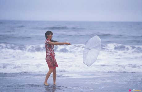 Bikini clad Yuriko Shiratorio shows off her body in the rain