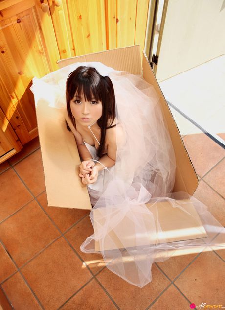 Asian babe Kana Moriyama gets naked in white stockings on a sofa