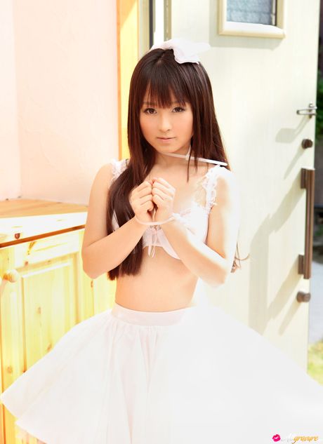 Asian babe Kana Moriyama gets naked in white stockings on a sofa