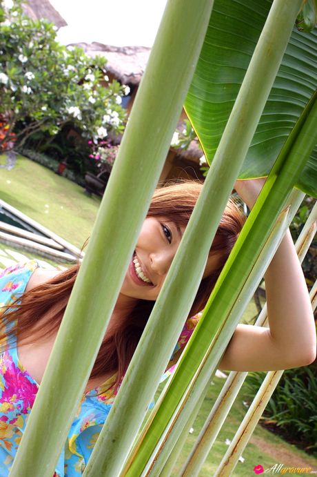 Asian doll Yua Aida gets naked on a blanket in high heels