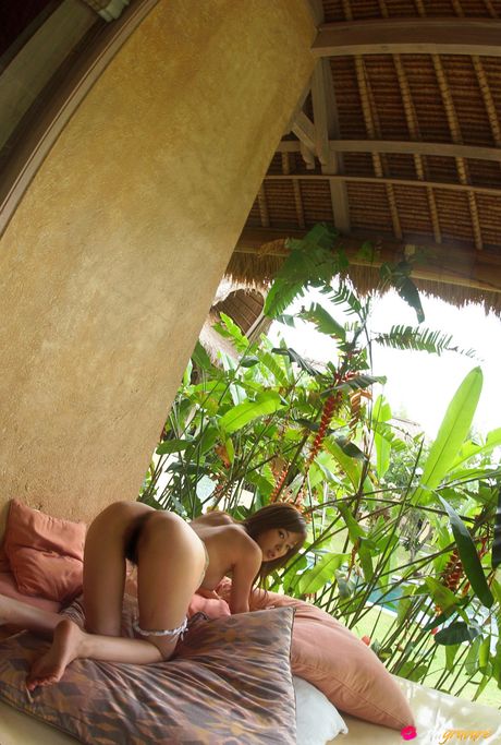 Asian doll Yua Aida gets naked on a blanket in high heels