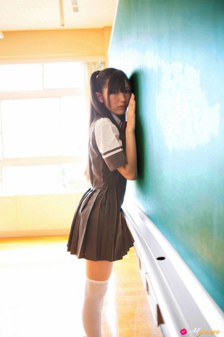 Asian schoolgirl Mayu Watanabe flaunts her nice tits and poses in stockings