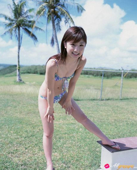 Bikini clad Yuko Ogura shows off her natural tits outdoors