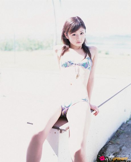 Bikini clad Yuko Ogura shows off her natural tits outdoors