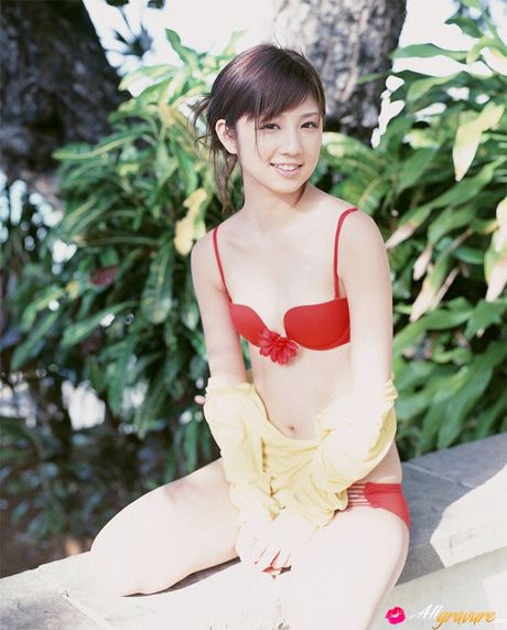 Bikini clad Yuko Ogura shows off her natural tits outdoors