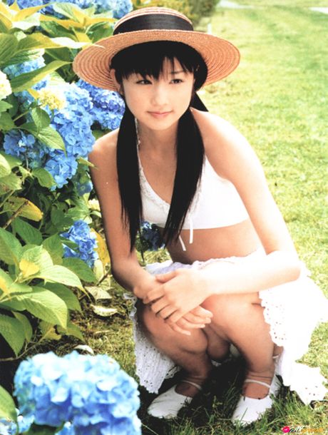 Asian girl Yuko Ogura unveils her small tits and poses in a solo