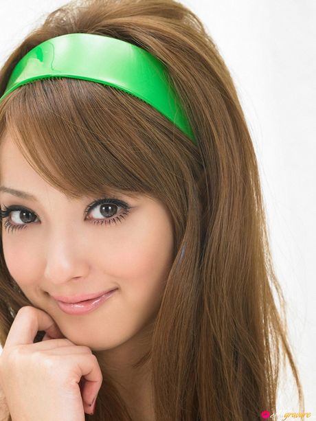 Asian teen Nozomi Sasaki gets naked on a sofa in a cheerleader uniform