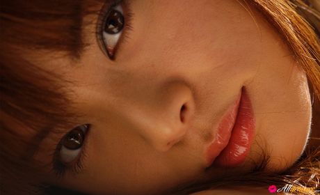 Asian covergirl Maria Takagi gets naked on a bed before masturbating