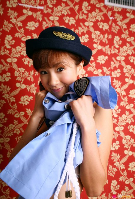 Asian doll Aki Hoshino displays her flat tits and poses in a police uniform
