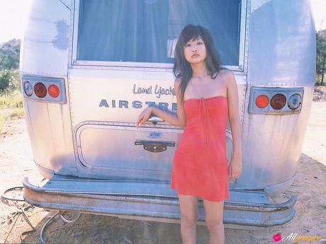 Asian teen Risa Kudo demonstrates her nice tits and poses in a red dress