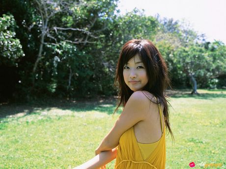 Asian teen Risa Kudo demonstrates her nice tits and poses in a red dress
